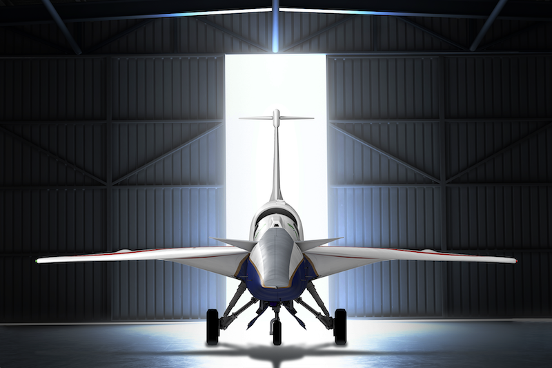 X-59: A sleek red, white, and blue plane stands before the bright white light of an opening hangar.