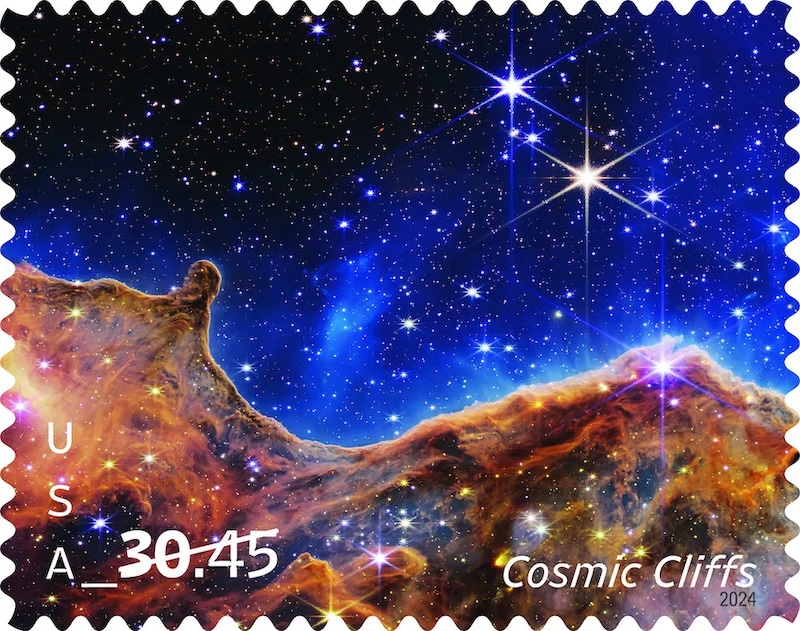 Wave-like shape of glowing yellowish gas, with tenuous blue gas above it and many bright foreground stars.