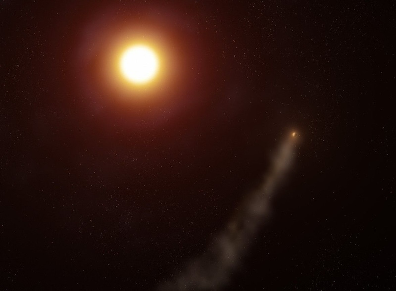 Exoplanet with a tail: Tiny glowing planet with long, dim, smoky-appearing tail near a large bright star.