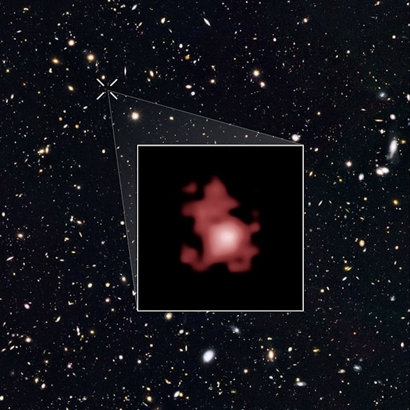 Oldest-known black hole: Reddish irregular blob in inset surrounded by thousands of other small bright blobs and dots on black background.