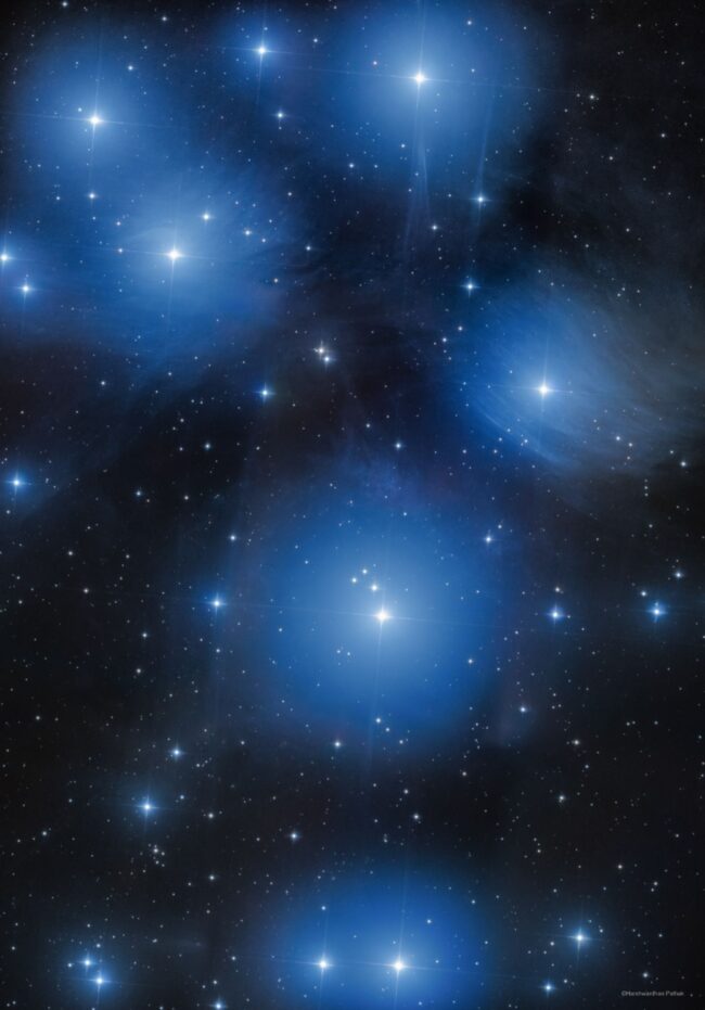 Large area of intense blue nebulosity with bright stars immersed within.