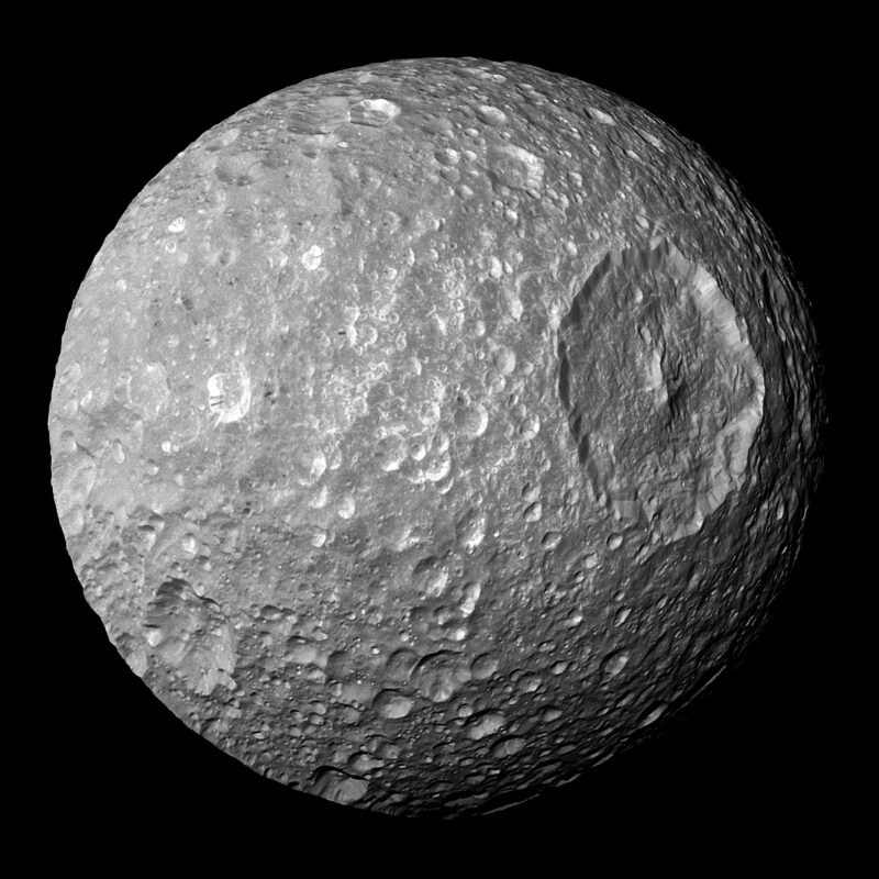 Death Star moon Mimas: Round, heavily cratered moon with one gigantic crater.