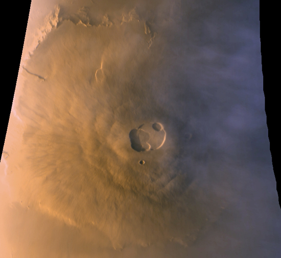 Volcanoes on Mars: Large volcano on brown terrain seen from above, with wide slopes and distinct central crater.