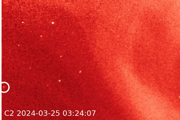 5000th comet: An orangish background with a faint, lighter color blur circled, moving across the scene.