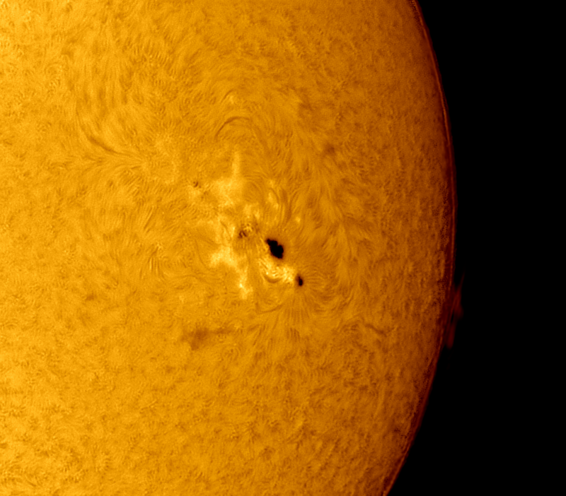 Half right of the sun with a dark area divided in 2 spots, 1 bigger than the other.