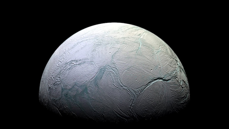 Light-blue planet-like body with cracks on an otherwise smooth surface.