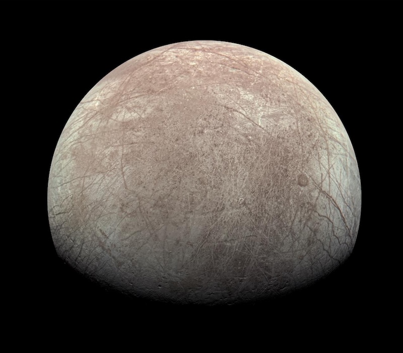 Oxygen on Europa: Tan and white moon-like body in space with many long cracks and lines on its surface.