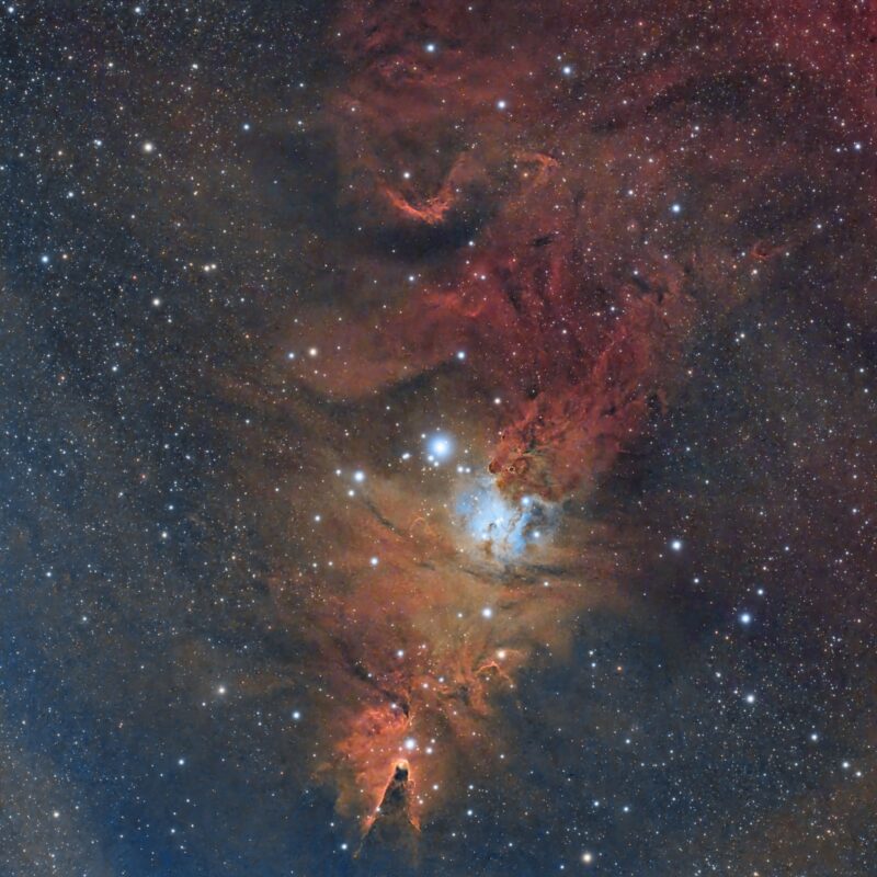 Large, complex orange nebulosity with numerous background stars.