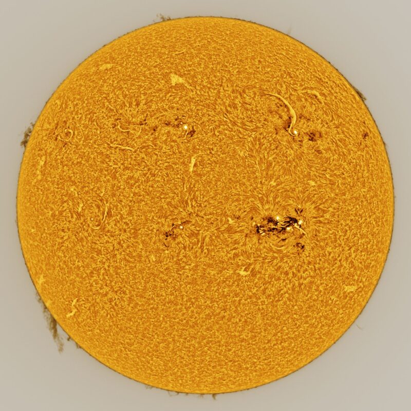 The sun, seen as a large yellow sphere with a mottled surface.