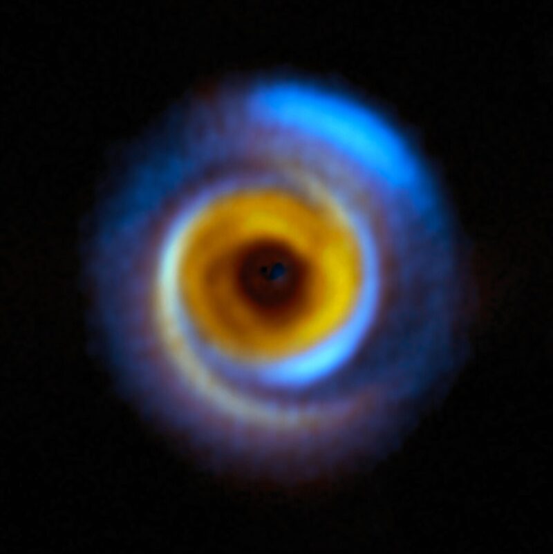 Dark center with blue and orange spiral swirls making up a disk shape.