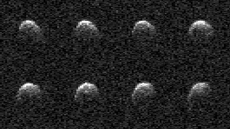 Asteroid: Eight fuzzy gray roundish shapes on black pixelated background.