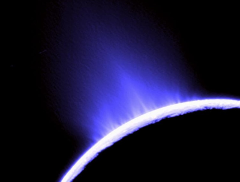 Enceladus: Sunlit edge of planet-like body with blue vapour-like jets erupting into space.