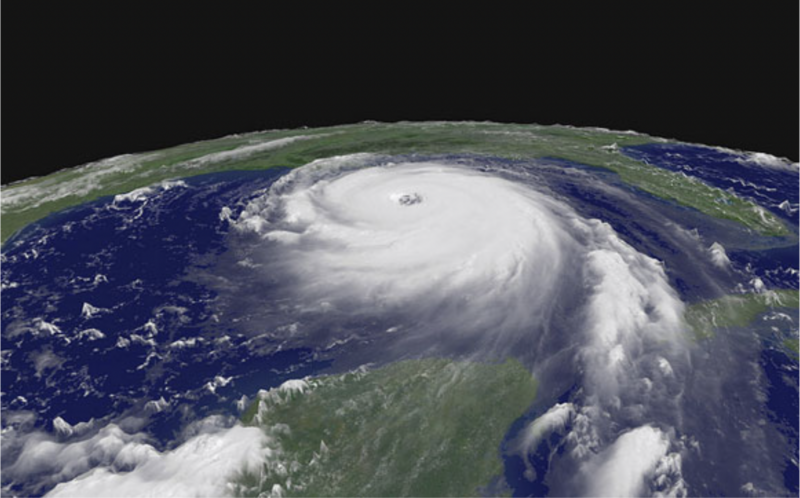 Large round white hurricane seen from above, with distinct spirals and eye, in Gulf of Mexico with green land areas visible.