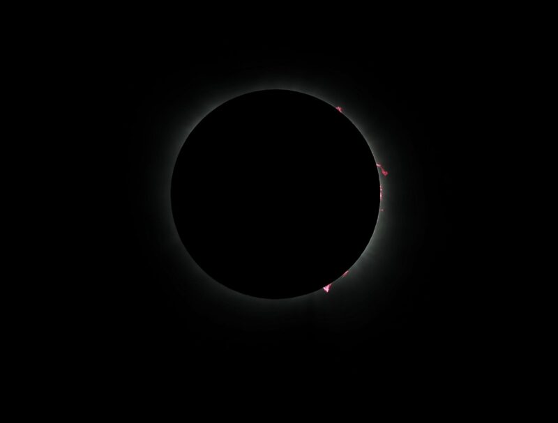 A dark circle with little bits of light around the circumference.