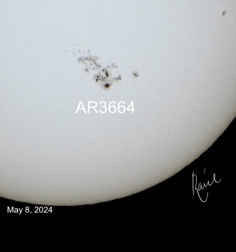 Giant sunspot: Corner of the sun shown in black and white with a large mottled area labeled AR3664.