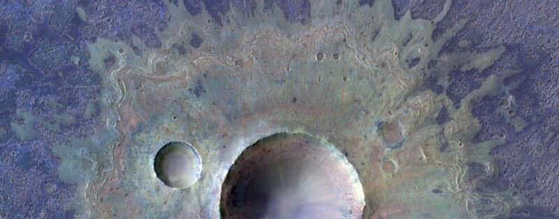 Two smooth-sided craters with large splatters around them, in shades of tan and purple.