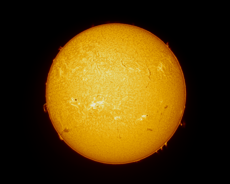 The sun, seen as a yellow sphere with a mottled surface.
