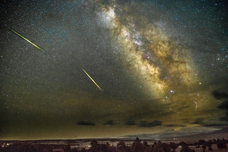 Starry sky with rich Milky Way and two meteor streaks.
