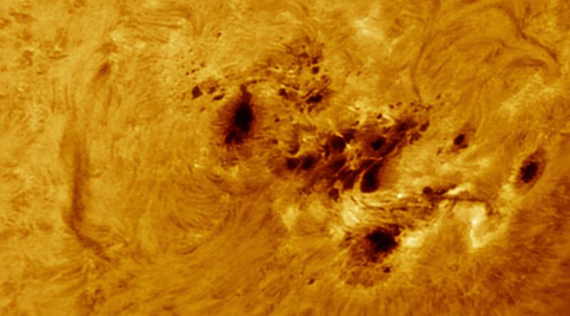 A sun close-up, seen as a flat yellow surface with a mottled surface.