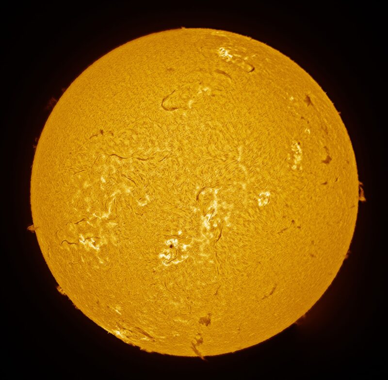 The sun, seen as a yellow sphere with a mottled surface.