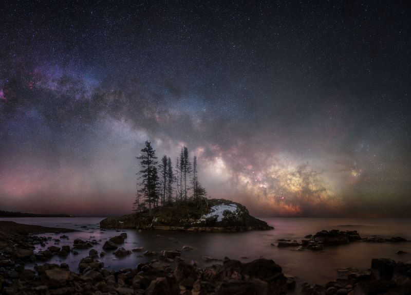 Best Milky Way photos: Trees on an island stand in front of a glowing Milky Way.