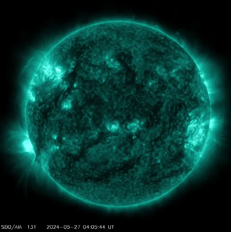 Animation of a sun in teal color showing bright spots as explosions occur on the solar disk.