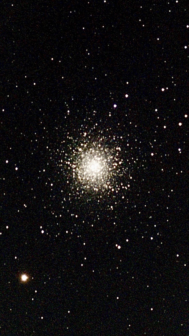 A large, globular cluster of thousands of bright yellow stars.