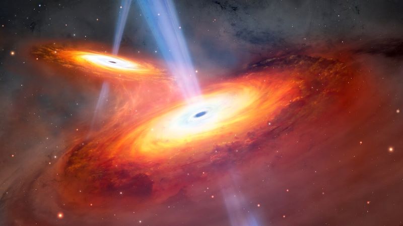 Merging quasars: Two spiral disks glowing yellow to orange, with jets coming out. The disks are close together.