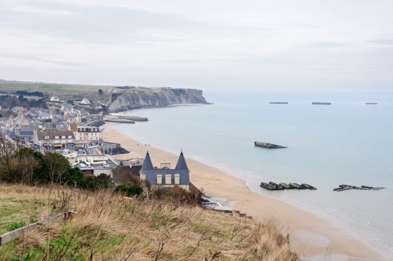 Arromanches-les-Bains, Normandy, France, with the remains of the portable temporary Mulberry harbor in its bay.