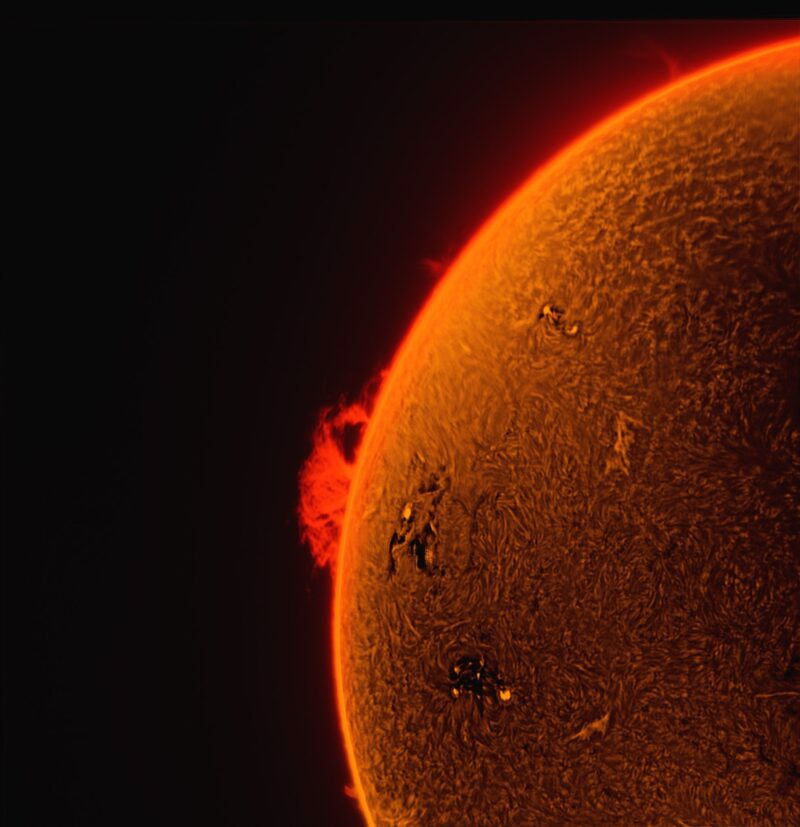 The sun, seen as a sectional orange sphere with a mottled surface.