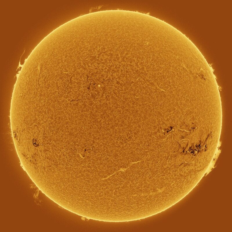 The sun, seen as a large yellow sphere with a mottled surface.