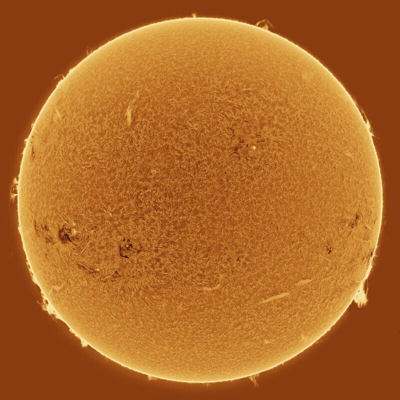 The sun, seen as a large yellow sphere with a mottled surface.