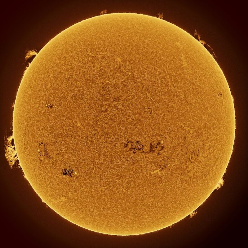 The sun, seen as a large yellow sphere with a mottled surface.