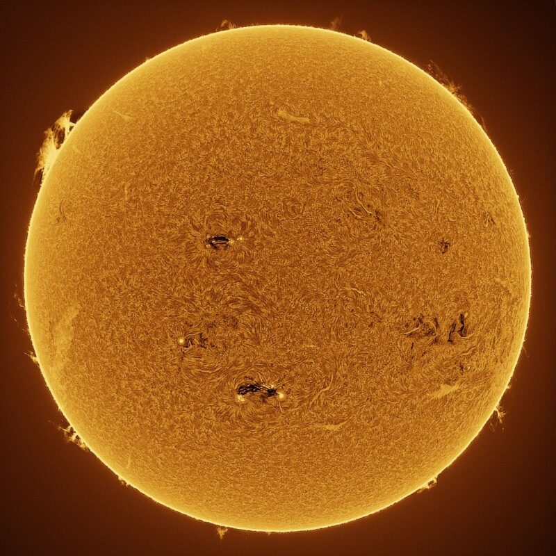 The sun, seen as a large yellow sphere with a mottled surface.