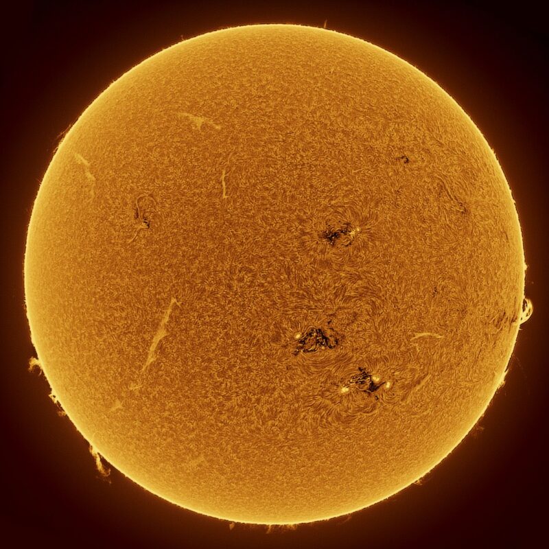 The sun, seen as a large yellow sphere with a mottled surface.