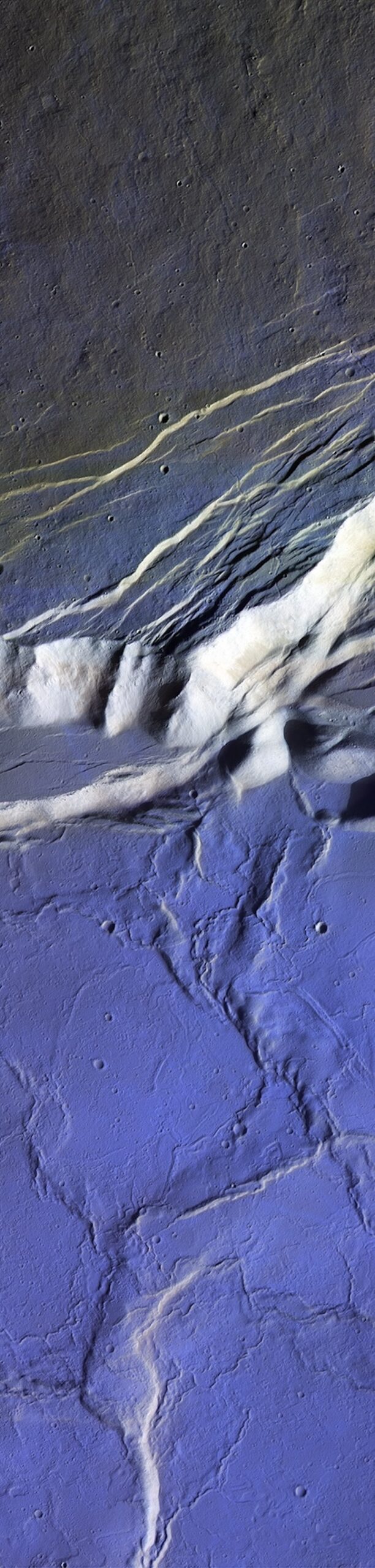 Bluish terrain with many meandering ridges and cracks.
