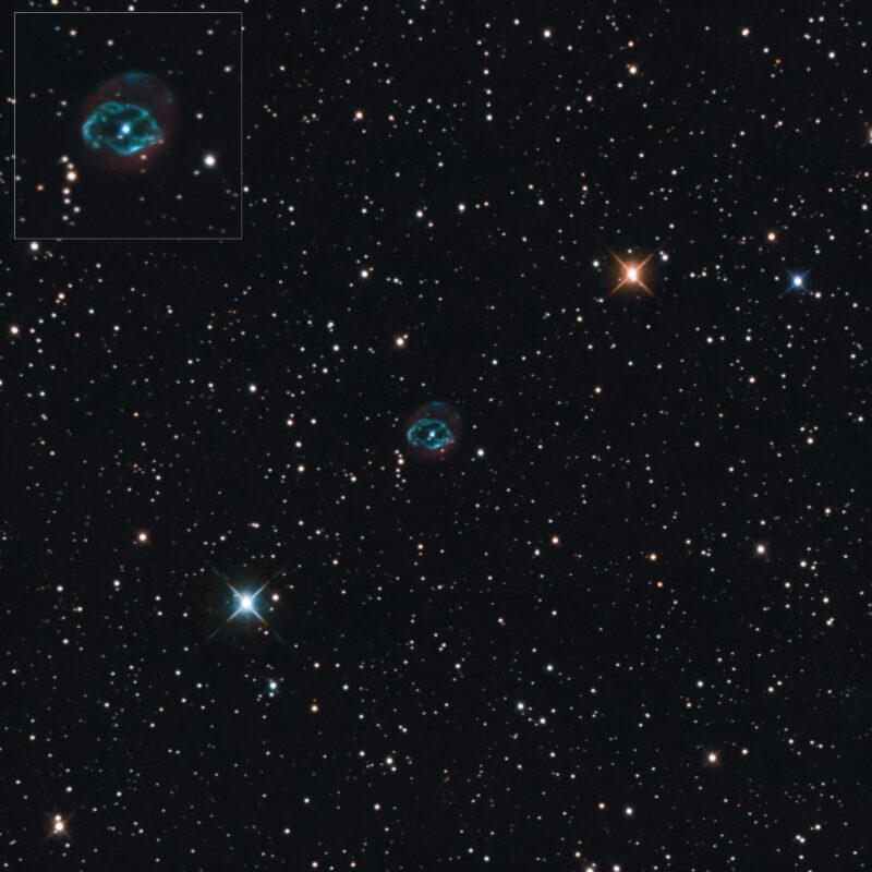 A small, oval-shaped ring made of blue and red gad with a background of numerous stars.