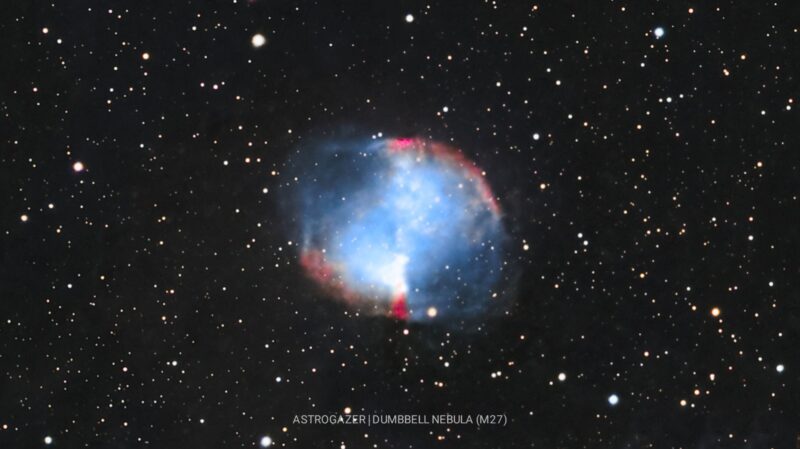 Large, spherical cloud of gas in electric blue and reddish highlights, with background stars.