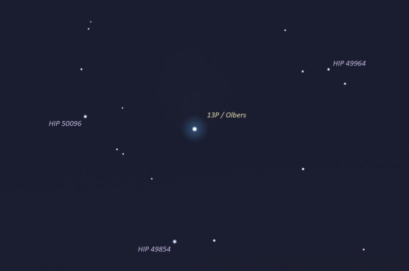 Fuzzy comet at center with somewhat bright stars nearby with labels.