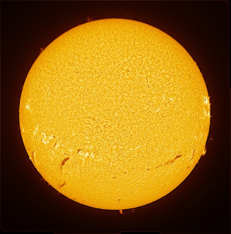 The sun, seen as a large yellow sphere with a mottled surface.