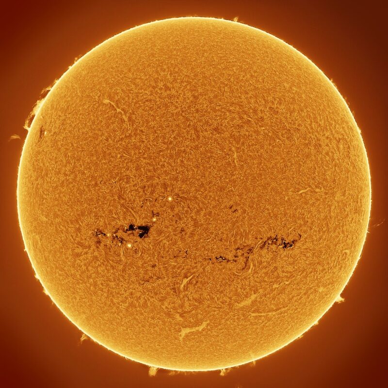 The sun, seen as a large yellow sphere with a mottled surface.