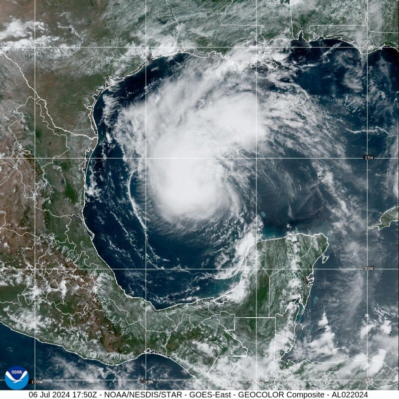 Hurricane Beryl: A white swirl of clouds over blue ocean surrounded by land. Image overlayed by horizontal and vertical white gridlines.