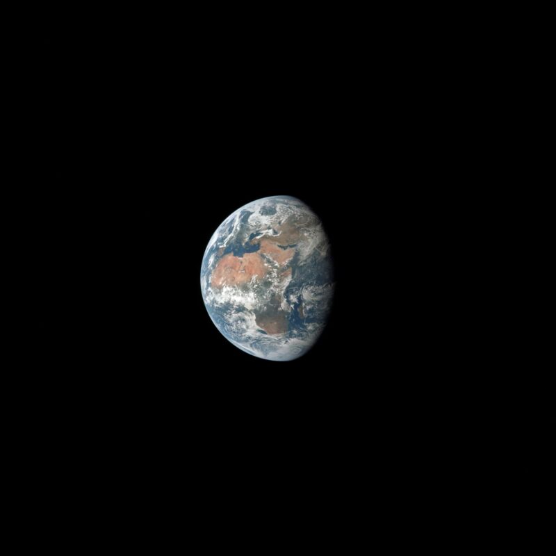 Earth, more than half lit, hanging in space with Africa and the Middle East visible through clouds.