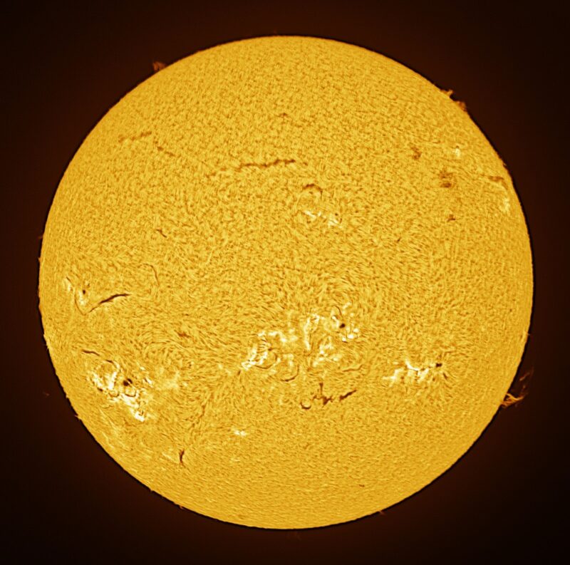 The sun, seen as a large yellow sphere with a mottled surface.