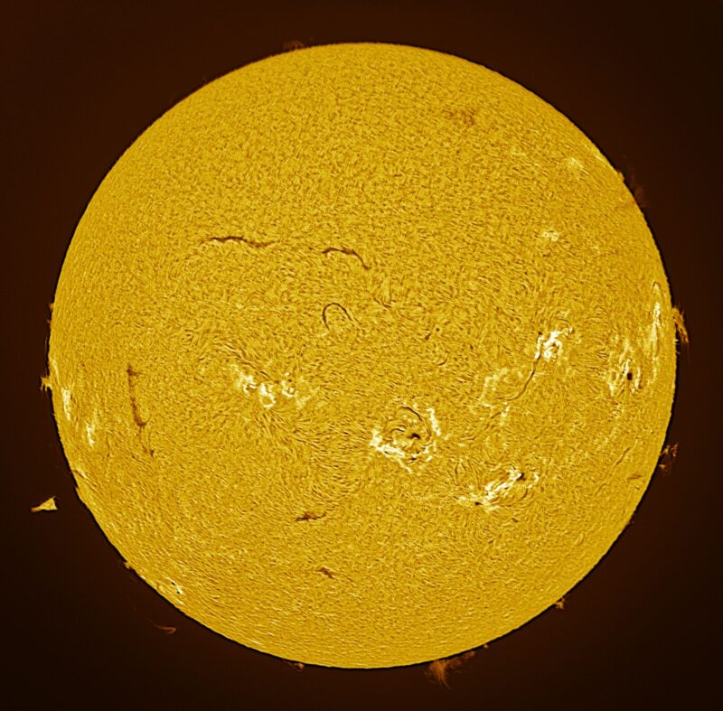 The sun, seen as a large yellow sphere with a mottled surface.