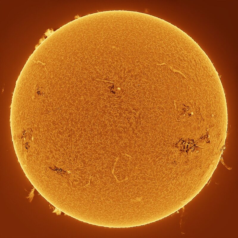 The sun, seen as a large yellow sphere with a mottled surface.