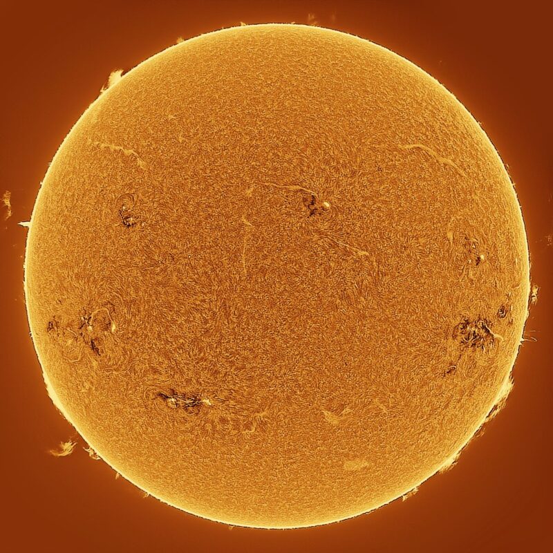 The sun, seen as a large yellow sphere with a mottled surface.