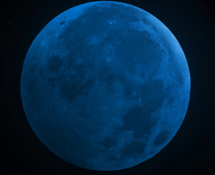 A full round blue-colored moon. A blue sphere with dark blotches on it.