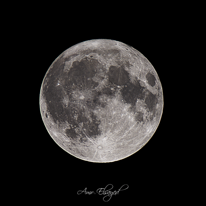 Large areas of black in the middle and lighter areas at top and bottom of a sphere in a black background.