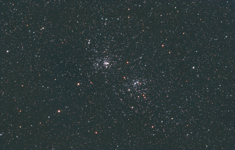 Two rich groupings of blue stars (and sparse orange stars), in a field of numerous fainter stars.